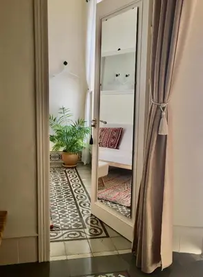 a hallway with a mirror and a couch in a room at Número 9 in Medina Sidonia