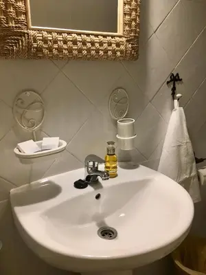 a white sink in a bathroom with a mirror at Número 9 in Medina Sidonia