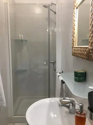 a bathroom with a shower and a white sink at Número 9 in Medina Sidonia