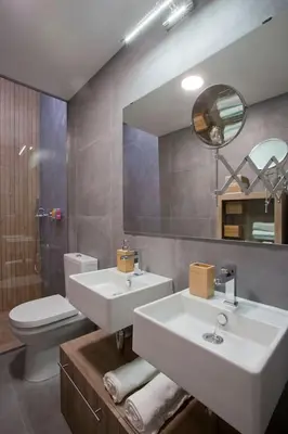 a bathroom with two sinks and a toilet and a mirror at GATU Villa Alameda in Cádiz