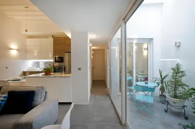 a living room and kitchen with a couch and a table at GATU Villa Alameda in Cádiz