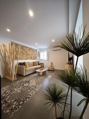 a living room with a couch and a table at Apartamento El Tanguillo Little Apartments in Cádiz