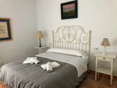a bedroom with a bed with towels on it at Chalet La Costa in Chiclana de la Frontera