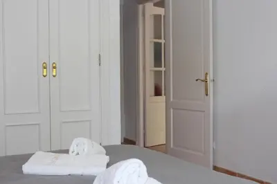 a bedroom with two towels sitting on top of a bed at Chalet La Costa in Chiclana de la Frontera