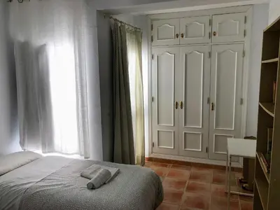 a bedroom with a bed with two towels on it at Chalet La Costa in Chiclana de la Frontera