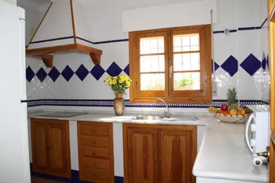 a kitchen with a sink and a vase of flowers at Apartamento Caracola in Chipiona