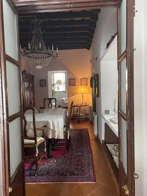 a room with a bed and a chandelier at Casa Antigua - Terraza con Vistas al Mar in Medina Sidonia