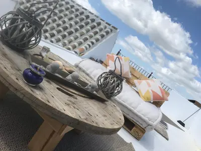 a wooden table in front of a building at Casa Antigua - Terraza con Vistas al Mar in Medina Sidonia