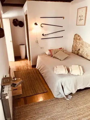 a bedroom with a bed and a table in it at Casa Antigua - Terraza con Vistas al Mar in Medina Sidonia