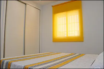 a bedroom with a bed and a window at Chalet Peñuelas con piscina in Conil de la Frontera