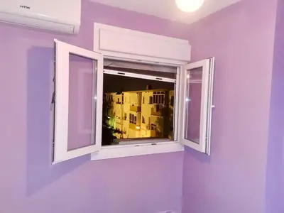 a window in a room with purple walls at Modern Seaside Apartment 700 mt from beach in El Puerto de Santa María