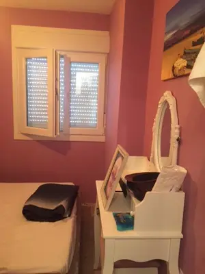 a bedroom with a bed and a mirror and a sink at Modern Seaside Apartment 700 mt from beach in El Puerto de Santa María