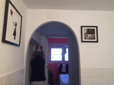 a person standing in front of a mirror in a room at Modern Seaside Apartment 700 mt from beach in El Puerto de Santa María