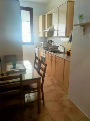 a kitchen with a table and a table and chairs at Apartamento en pleno centro de Cadiz con parking economico in Cádiz