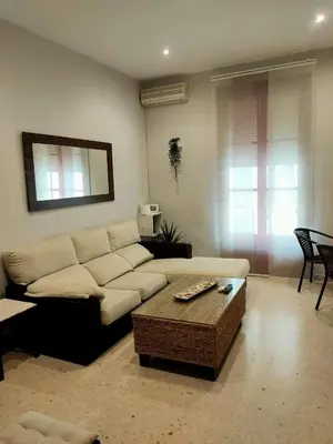 a living room with a couch and a coffee table at Apartamento en pleno centro de Cadiz con parking economico in Cádiz