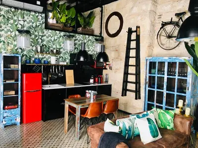 a kitchen with a table and a red refrigerator at Semiloft Romantico Catedral con soleada azotea comunitaria in Jerez de la Frontera