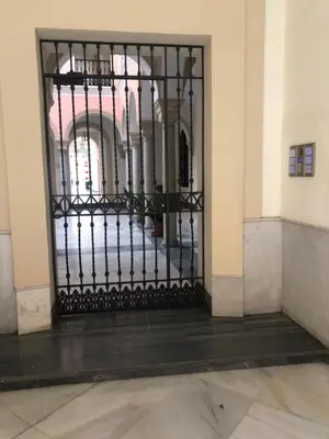 a black gate in a room with a building at Apartamento semi-industrial palacio Castilla in Jerez de la Frontera