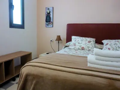 a bedroom with a bed with towels on it at APARTAMENTO APODACA in Cádiz