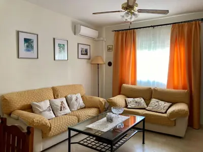 a living room with a couch and a table at Casa Valdelagrana Playa in El Puerto de Santa María