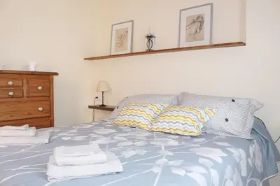 a bedroom with a bed with towels on it at Casa Valdelagrana Playa in El Puerto de Santa María