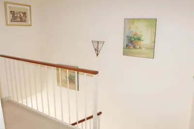 a staircase with a painting and a picture on the wall at Casa Valdelagrana Playa in El Puerto de Santa María