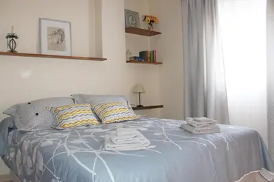 a bedroom with a bed with towels on it at Casa Valdelagrana Playa in El Puerto de Santa María