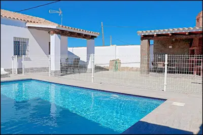 a swimming pool in front of a house at Chalet Ermita in Conil de la Frontera