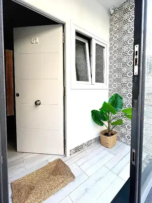 a door in a house with a plant next to it at Apartamento Centro San Diego in Sanlúcar de Barrameda