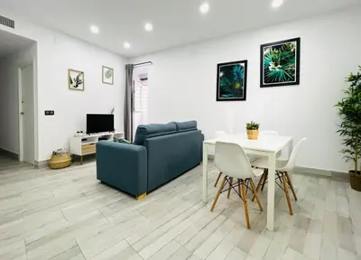 a living room with a couch and a table at Apartamento Centro San Diego in Sanlúcar de Barrameda