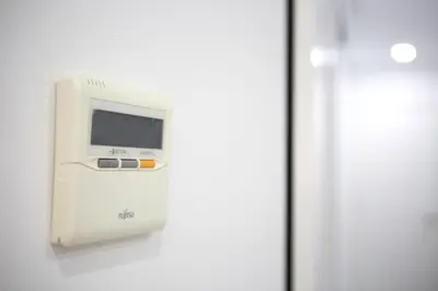 a white machine on a wall next to a door at Apartamento Centro San Diego in Sanlúcar de Barrameda