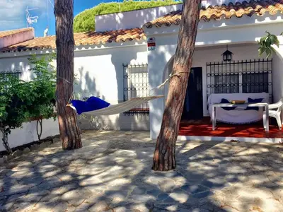 a hammock in the courtyard of a house at Charming House + Chiclana de la Frontera + Garden in Chiclana de la Frontera
