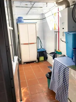 a room with a table and a door in a room at Charming House + Chiclana de la Frontera + Garden in Chiclana de la Frontera