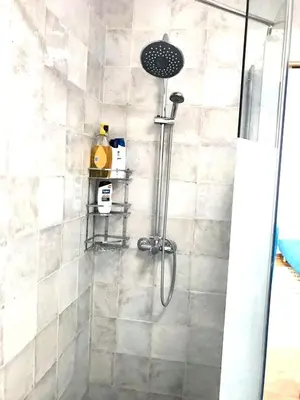 a bathroom with a shower with a glass door at Charming House + Chiclana de la Frontera + Garden in Chiclana de la Frontera