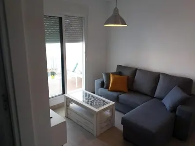 a living room with a couch and a coffee table at Apartamento Carlos in Rota