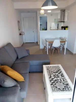 a living room with a couch and a table at Apartamento Carlos in Rota