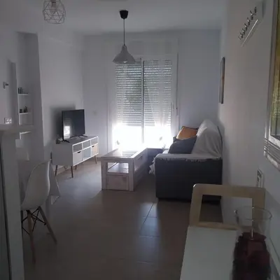 a living room with a couch and a table at Apartamento Carlos in Rota