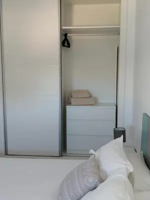 a mirror in a bedroom with a bed and a closet at Apartamento Carlos in Rota