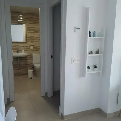 a white bathroom with a sink and a toilet at Apartamento Carlos in Rota
