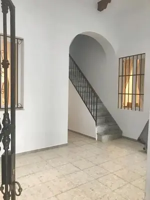 a staircase in a white room with a window at Spacious apartment in Cádiz 130 m² with balcony and city view in Cádiz