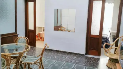 a dining room with a glass table and chairs at Spacious apartment in Cádiz 130 m² with balcony and city view in Cádiz
