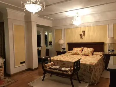 a bedroom with a bed and a table and chandeliers at Bahía blanca SM in Cádiz