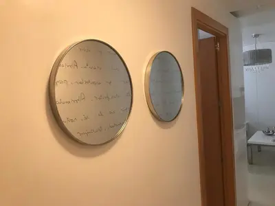 two mirrors hanging on a wall with writing on them at Apartamento Cadiz de Cine in Cádiz