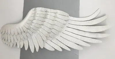 a white vase with wings on a wall at Apartamento Cadiz de Cine in Cádiz