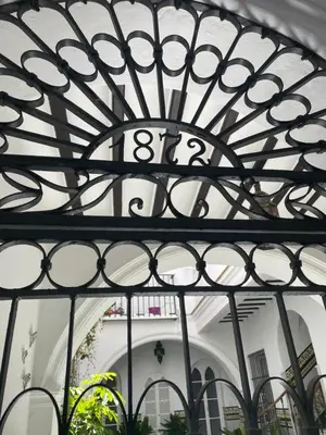 a black iron gate with the word on it at Lujosa suite privada en casa del S XIX in Sanlúcar de Barrameda