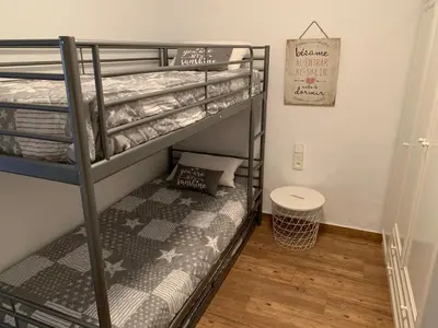 a bunk bed room with two bunk beds at Chalet adosado playa de La Barrosa in Chiclana de la Frontera