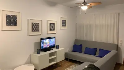 a living room with a couch and a flat screen tv at Chalet adosado playa de La Barrosa in Chiclana de la Frontera