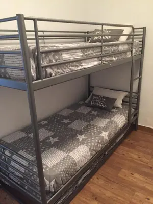 a metal bunk bed in a room at Chalet adosado playa de La Barrosa in Chiclana de la Frontera