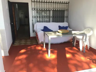 a living room with a couch and a table at Chalet adosado playa de La Barrosa in Chiclana de la Frontera