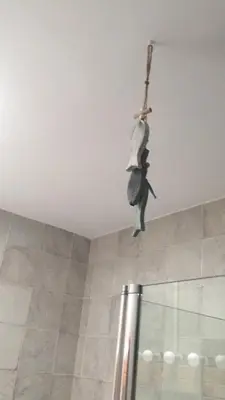 a person hanging from a cross on a ceiling at Chalet adosado playa de La Barrosa in Chiclana de la Frontera