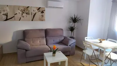 a living room with a couch and a table at Loft 500 metros de la playa in Cádiz